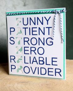 a white and blue sign sitting on top of a wooden table next to a green wall