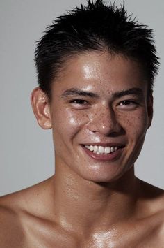 a man with freckled hair smiling at the camera