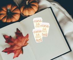 an open book with fall stickers on it