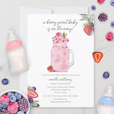 a baby shower is shown with berries and milk