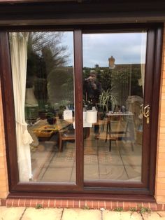 a person standing in front of a sliding glass door