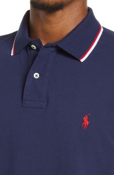 Iconic branding stamps a classic polo shirt shaped from pure cotton. 28 1/2" length (size Medium) Button half-placket Spread collar Short sleeves Straight hem 100% cotton Machine wash, tumble dry Imported Men's Clothing Classic Polo Shirt With Ribbed Collar For Golf, Classic Golf Polo Shirt With Ribbed Collar, Classic Cotton Polo Shirt For Golf, Classic Blue Polo Shirt For Golf, Classic Golf Polo Shirt With Placket, Classic Cotton Polo Shirt With Johnny Collar, Classic Golf Tops With Placket, Classic Navy Collared Top, Classic Navy Polo Shirt With Ribbed Collar