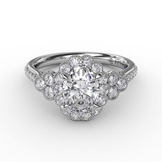 an oval shaped diamond ring with halos on the sides