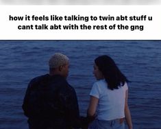 a man and woman standing next to each other near the water with an ad in front of them that says how it feels like talking to twin