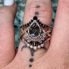 a close up of a person's hand with a ring on it