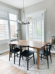 a dining room table with four chairs around it