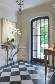 a room with a checkered floor and an ornate table