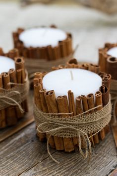 cinnamon sticks wrapped in twine with a candle