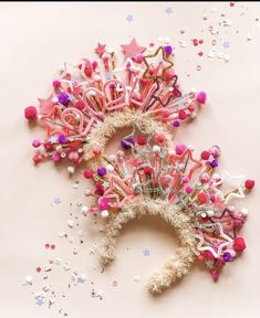 two pink and white hair combs on top of confetti sprinkles