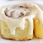 a white plate topped with a pastry covered in icing