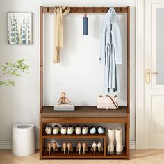 a coat rack with shoes and clothes hanging on it