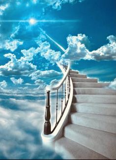 a stairway leading up into the sky with clouds