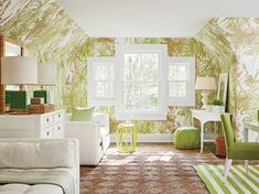 a living room filled with furniture and green chairs next to a white table in front of a window