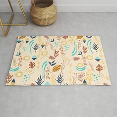 a rug with an abstract design on the floor next to a basket and plant pot