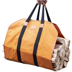 a person holding a large bag full of wood logs in front of a white background