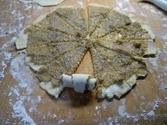 an uncooked pizza sitting on top of a wooden cutting board