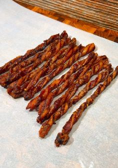 several strips of bacon sitting on top of a piece of paper