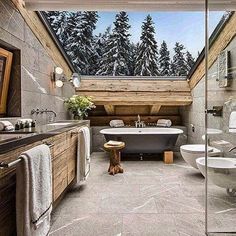 a bathroom with a tub, sink, toilet and shower in the middle of it