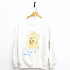 Vintage Dolly Parton Dollywood Sweatshirt Xl Condition: Light Stain On Back Sleeve, A Few Light Stains/Marks Throughout Tag Reads: Sherry 80% Cotton 20% Polyester Xl (Vintage Can Run Small, Check Measurements Below) Measurements: Length (Shoulder To End Of Garment): 24" Width (Armpit To Armpit): 20.5" Sleeve (Armpit To End Of Sleeve): 20" **I Like To Recommend You Compare The Measurements Listed To The Measurements Of A Shirt You Like The Fit Of To See If It Will Work** All Measurements Are Taken With The Garment Flat On The Ground. Convo With Questions. Light Stain, Dolly Parton, Vintage Shirts, Vintage Men, White Vintage, Mens Shirts, Man Shop, Sweatshirts Hoodie, Sweatshirts