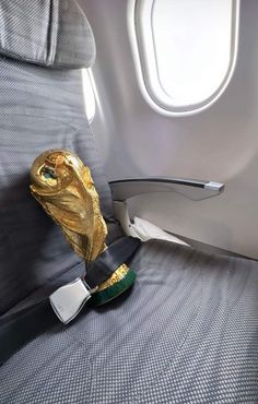 a gold object sitting on top of an airplane seat