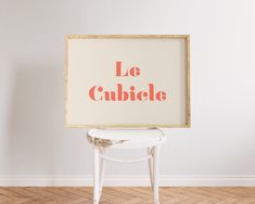 a white chair sitting in front of a sign that says le cauble on it