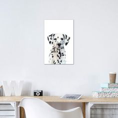 a dalmatian dog with black spots on it's face sitting in front of a desk