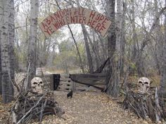 two skulls are sitting in the woods near a sign that says, deadwood hunt