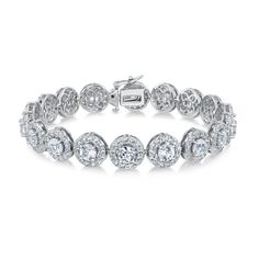 Refine your jewelry collection with this created gemstone tennis bracelet. Perfect for everyday wear, this sterling silver bracelet features created white sapphire halo stations. It can be worn by itself or stacked with other bracelets that best express your individuality. The bracelet measures 7.25 inches in length and 8.5mm in width. Elegant Silver Tennis Bracelet With Halo Setting, Formal Silver Tennis Bracelet With Halo Setting, Formal Tennis Bracelet With Halo Setting, Luxury Silver Bracelet With Halo Setting, Classic Formal Tennis Bracelet With Halo Setting, Fine Jewelry Tennis Bracelet With Halo Setting For Anniversary, Luxury Silver Diamond Bracelet With Halo Setting, Classic Cubic Zirconia Bracelets With Halo Setting, Elegant Bracelets With Halo Setting In Cubic Zirconia