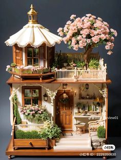 a doll house with flowers and plants on the porch, windows, doors, and balcony balconies