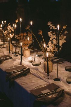 a long table with candles and flowers on it