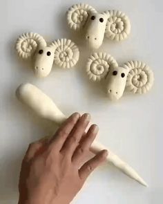 a hand reaching for some fake sheep heads