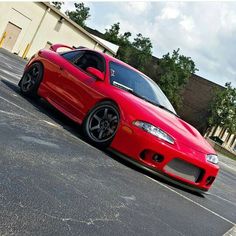 a red sports car parked in front of a building