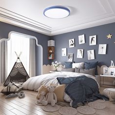 a bedroom decorated in blue and white with pictures on the wall above the bed, teddy bear