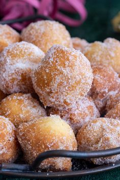 powdered sugar coated donuts in a bowl