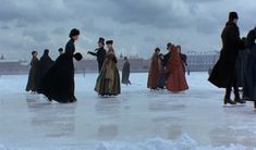 several people in long dresses are walking on the ice