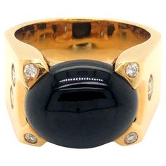 Oval shape cabochon black jade ring, prong set in 18k yellow gold. The Jade measures approximately 15.29 mm x 12.28 mm x 7.20 mm. The ring has a total of 7 round brilliant diamonds, bezel set. The total diamond weight is ~0.34 carats, G in color and SI1-SI2 in clarity. The ring has a tapered shank with a high polish finish. The ring is size 9.25 and can be easily re-sized for a small fee. Stamped "18k" and hallmarked "L Rafael" on the inside. Total weight is 24 grams. Preowned in Excellent condition. (Actual color of jade may slightly vary depending on screen calibration, lighting or camera settings. Please see image of ring on hand for more accurate color.) Item Specifications: Metal: 18k Yellow Gold Style: Statement Ring Ring Size: 9.25 (resizing available for a fee) Total Weight: 24 Gra Yellow Gold Jade Jewelry With Cabochon, Yellow Gold Jade Cabochon Ring, Yellow Round Jade Jewelry, Hand Rings, Luxury Cabochon Lapis Lazuli Rings, Luxury Lapis Lazuli Cabochon Rings, Camera Settings, Jade Ring, Diamond Clarity