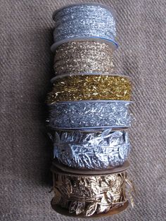 spools of silver and gold foil wrapped in twine on top of each other