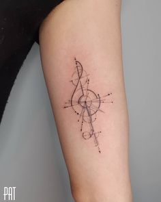 a woman's arm with a tattoo on it that has an arrow and compass