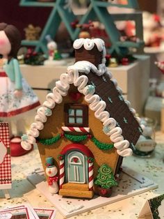 a gingerbread house decorated with icing and candy