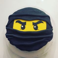 there is a cake with a face on it that looks like a ninja's head