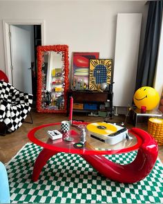 a living room filled with lots of furniture and decor on top of checkered rugs