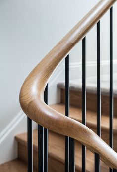 a wooden hand rail on a stair case