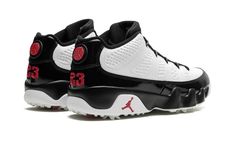 The Air Jordan 9 Golf “True Red” is the golf version of Michael Jordan’s ninth signature shoe in one of the model’s original colorways.  The “True Red” debuted on the Jordan 9 in the mid-90s and, here, it appears on the modified version of the retro basketball shoe made for the fairway.  The upper features a white leather base with glossy black leather accents.  A Team Red “Air Jordan” logo appears on the tongue tag, while a red globe emblem can be seen on the heel above red “23” embroidery.  Un Sporty Golf Shoes With Boost Midsole, Casual Golf Sneakers With Boost Midsole, Black Low-top Golf Sneakers, White Black Shoes, Air Jordan Logo, Retro Basketball Shoes, Jordan Logo, Mid 90s, Air Jordan 9