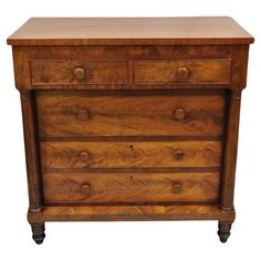 an old wooden dresser with three drawers and two knobs on the front, against a white background