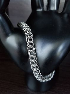 This lightweight chainmaille bracelet is perfect as a charm bracelet, or can be worn alone for singular style. It utilizes the Half Persian 3-in-1 weave and stainless steel construction to provide strength and durability. With minimal care, it could easily last a lifetime! Every ring is hand woven into place. An attractive addition to your collection, and appropriate for either a man or a woman. To care for your stainless steel jewelry, clean (or sonicate) with dishsoap, or lotion-free handsoap, Stainless Steel Chain Link Jewelry With Jump Ring, Stainless Steel Chainmail Bracelet As Gift, Silver Stainless Steel Chainmail Bracelet, Silver Chainmail Stainless Steel Chain Bracelet, Chainmaille Ring, Chainmaille Jewelry Patterns, Chainmaille Tutorial, Chainmaille Bracelet, Chain Maille Jewelry