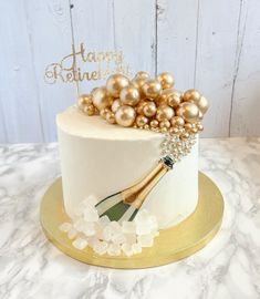 a white cake with gold decorations on top