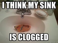 a bathroom sink with an orange slipper in it and the caption i think my sink is clogged