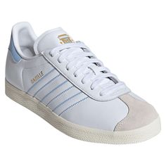 Make your Argentina National Team fandom evident with every step in these Gazelle shoes from adidas Originals. These feature a leather body with suede detailing at the toe. The subtle Argentina National Team design elements allow you to blend your team pride with your everyday look with ease. These are the perfect pair of shoes to wear for every match. Officially licensed Material: 100% Leather - Upper; 100% Rubber - Sole Rubber outsole Brand: adidas Originals Leather upper Wipe clean with a dam White Suede Adidas Logo Sneakers, Adidas High-top Leather Sneakers, High-top Leather Adidas Sneakers, Gazelle Shoes, Argentina National Team, Team Design, College Soccer, Adidas Originals Mens, Training Pants