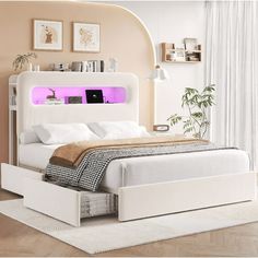 a white bed sitting in a bedroom next to a window with pink light on it