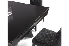 a black table with two chairs next to it and a wine glass on the side